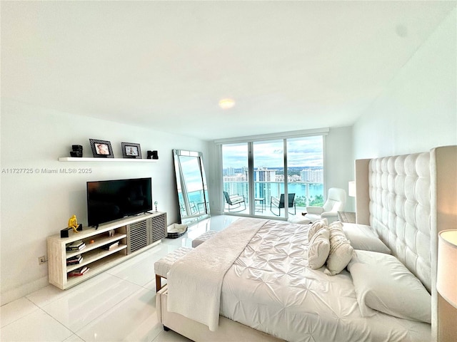 bedroom with a wall of windows, tile patterned floors, and access to exterior