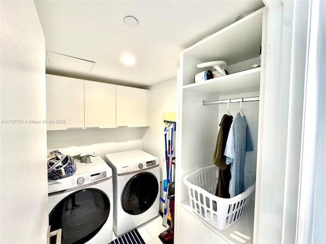 washroom featuring independent washer and dryer, tile patterned floors, and cabinets