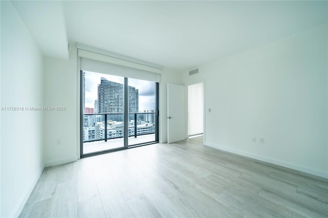 unfurnished room with light hardwood / wood-style flooring