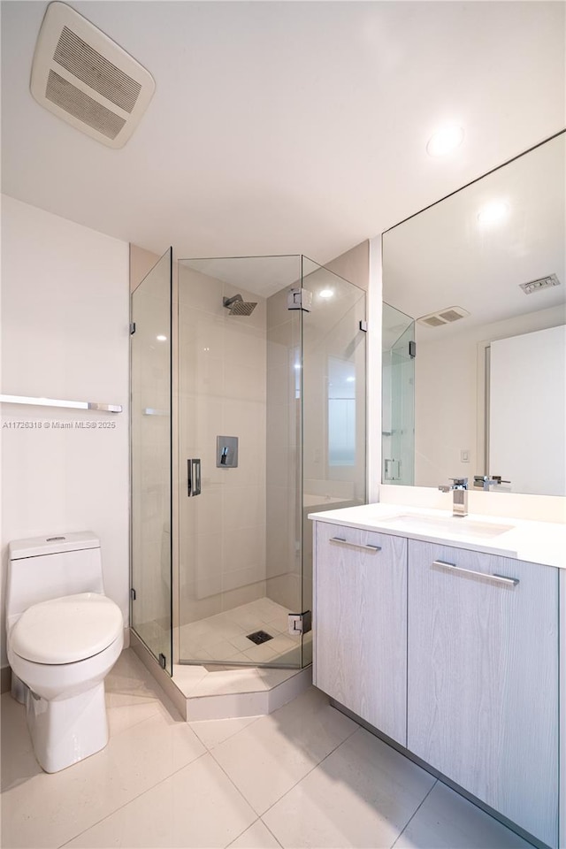 bathroom featuring toilet, tile patterned flooring, walk in shower, and vanity