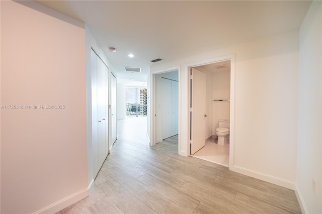 hallway with light wood-type flooring