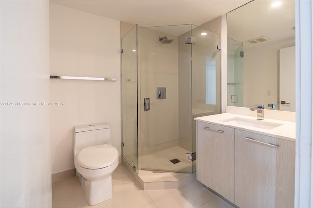 bathroom featuring toilet, vanity, tile patterned flooring, and an enclosed shower