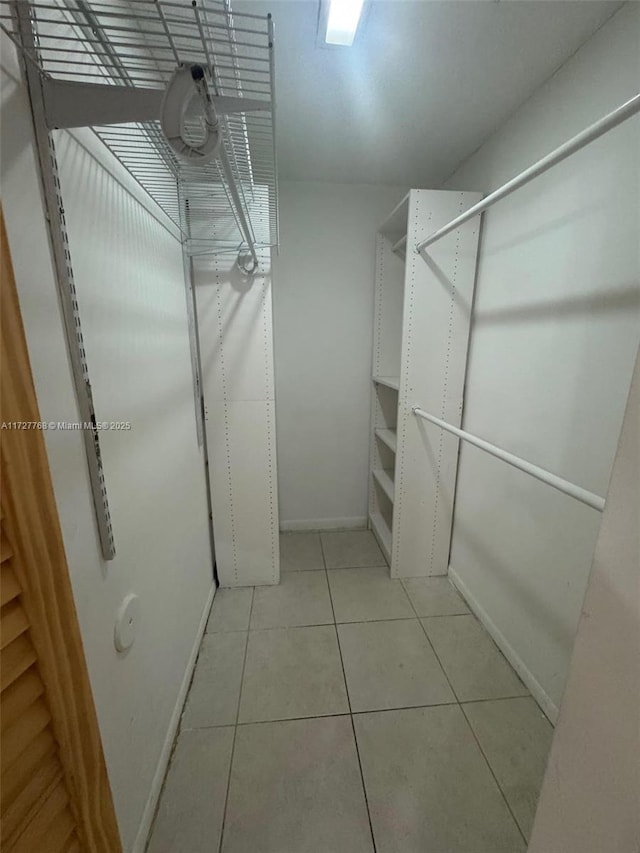 spacious closet with light tile patterned floors