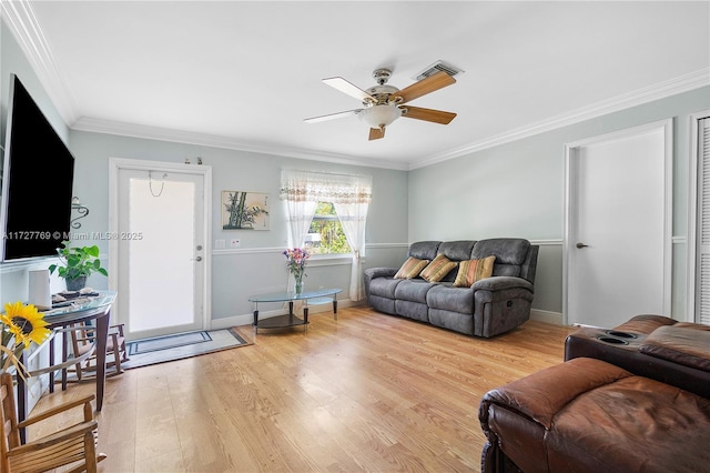 living room featuring ceiling fan, light hardwood / wood-style floors, and crown molding