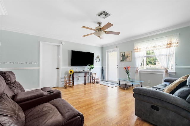 living room featuring ceiling fan, light hardwood / wood-style flooring, and ornamental molding