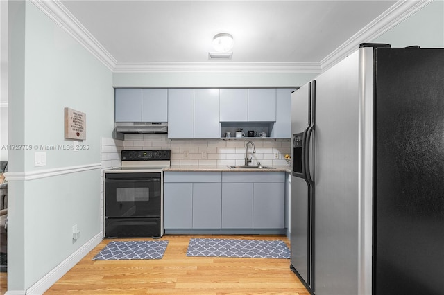 kitchen with stainless steel fridge, gray cabinetry, decorative backsplash, electric stove, and sink