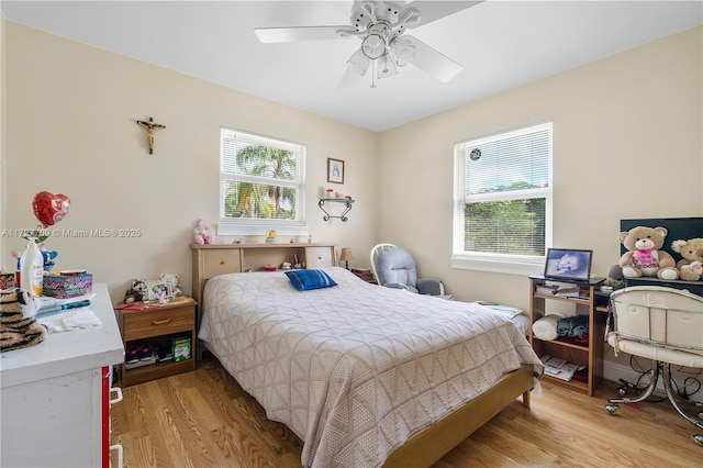 bedroom with ceiling fan and light hardwood / wood-style floors