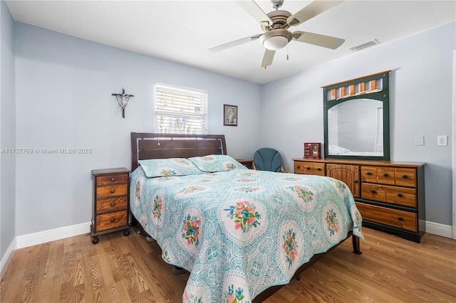 bedroom with ceiling fan and light hardwood / wood-style floors