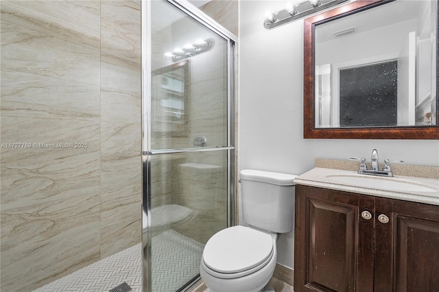 bathroom featuring toilet, a shower with door, and vanity