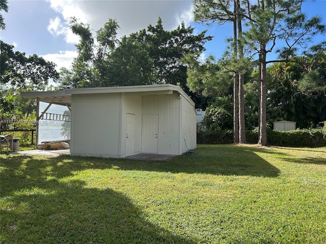 view of outbuilding with a yard