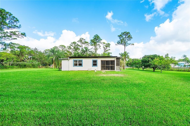 back of property with a lawn