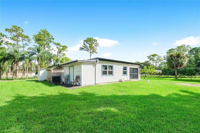 back of house with a yard and central AC unit