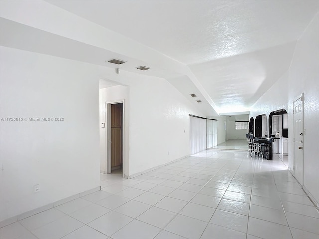 unfurnished living room featuring light tile patterned floors