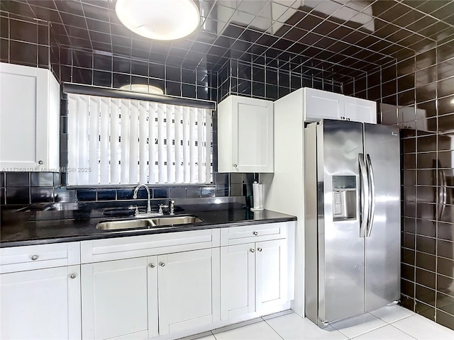 kitchen with white cabinets, sink, stainless steel fridge with ice dispenser, and light tile patterned floors