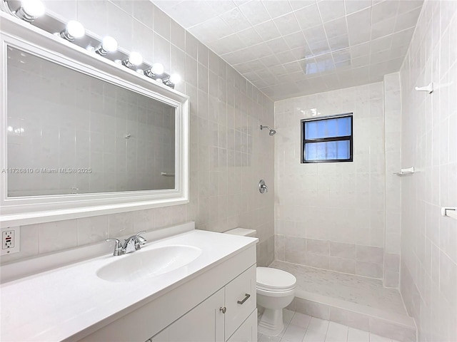 bathroom featuring toilet, tile walls, and tiled shower