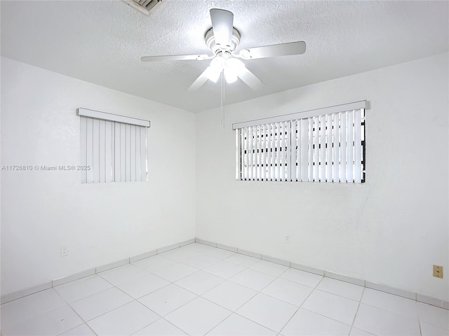 spare room featuring ceiling fan and a textured ceiling