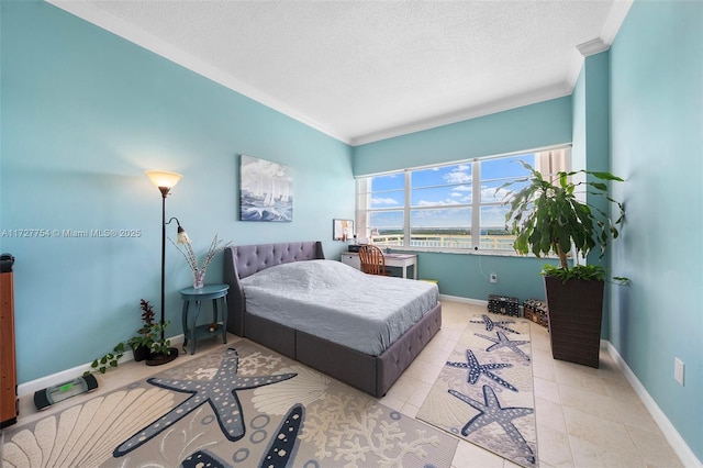 bedroom with crown molding, light tile patterned flooring, and a textured ceiling