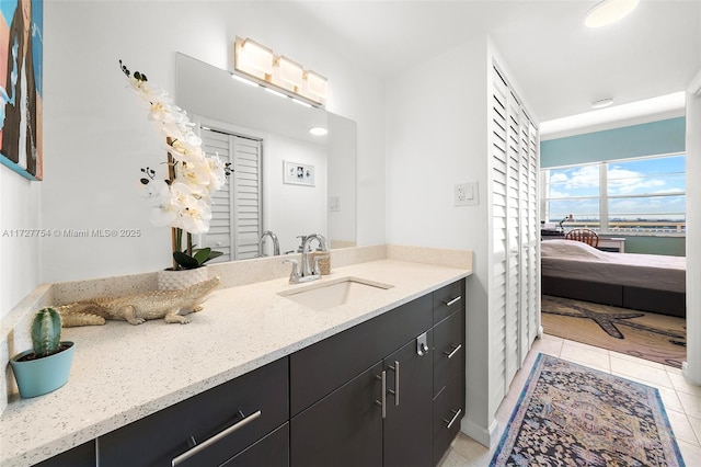 bathroom with vanity, tile patterned flooring, and a water view