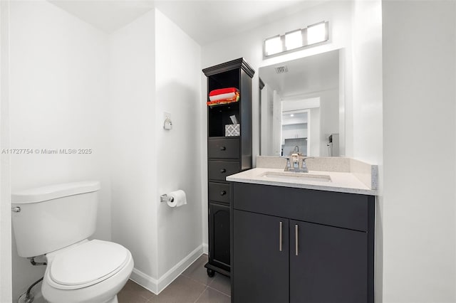 bathroom featuring vanity, toilet, and tile patterned flooring