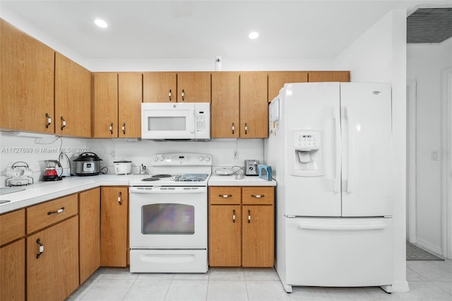 kitchen with white appliances and light tile patterned flooring