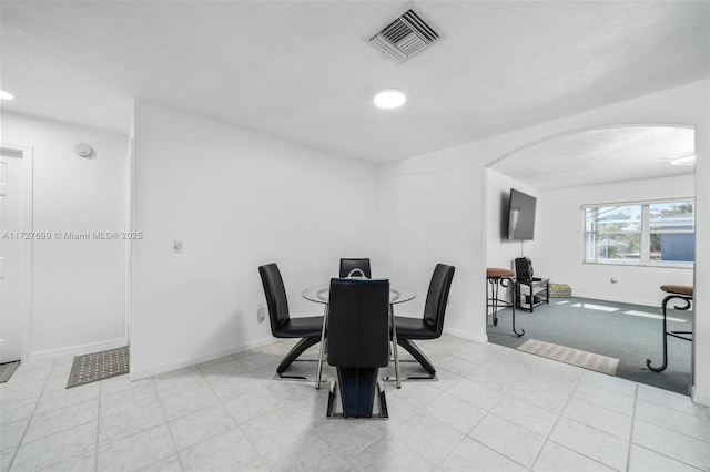 dining room featuring light colored carpet