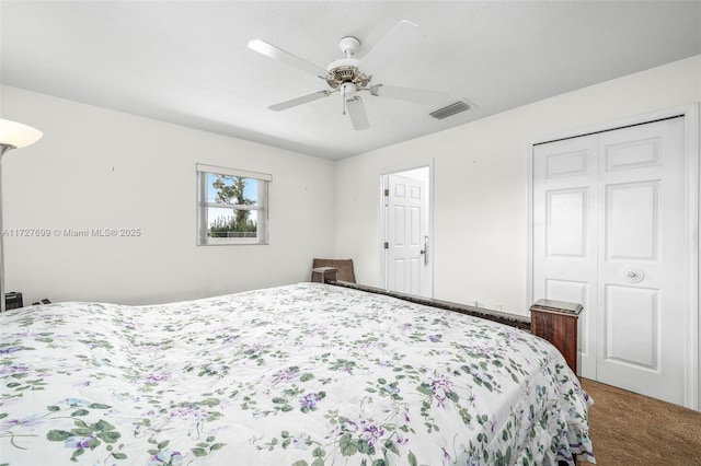 carpeted bedroom with ceiling fan and a closet