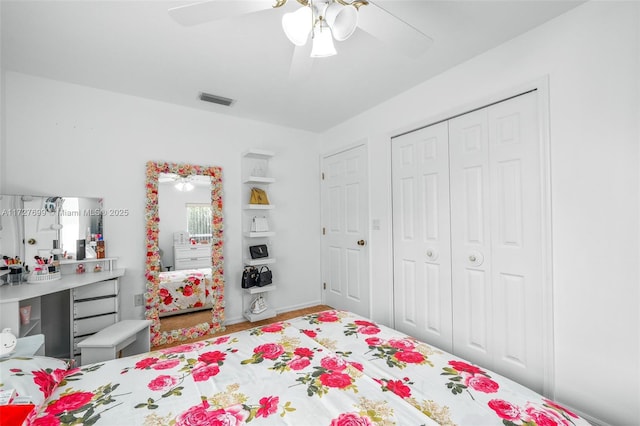 bedroom with ceiling fan and a closet