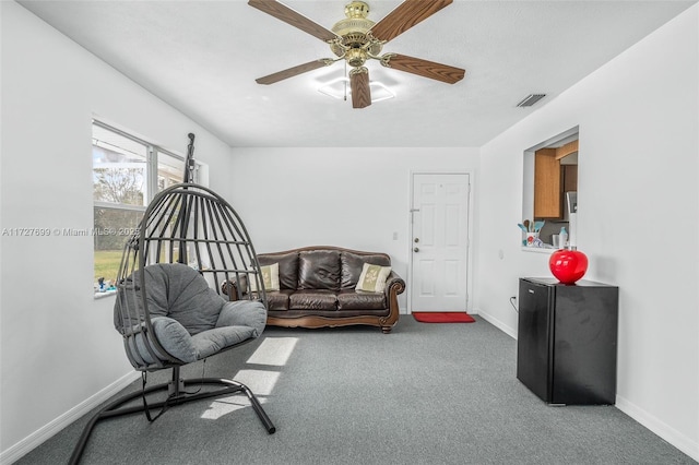 sitting room with ceiling fan and carpet floors