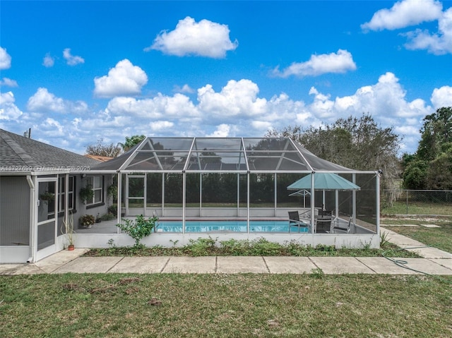 view of swimming pool with a lanai, a lawn, and a patio