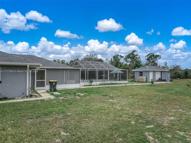 back of property featuring a lanai and a yard