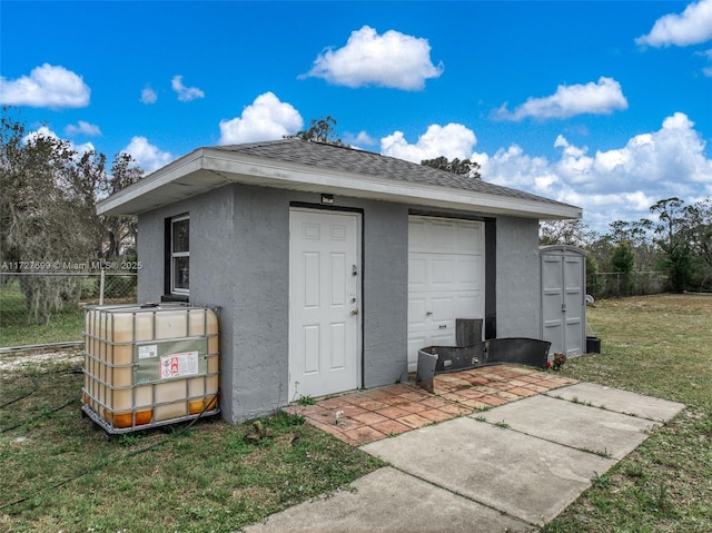 view of outbuilding with a yard and a garage