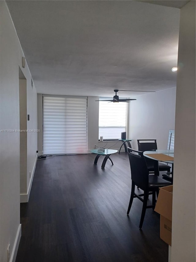 dining area featuring ceiling fan and dark hardwood / wood-style floors