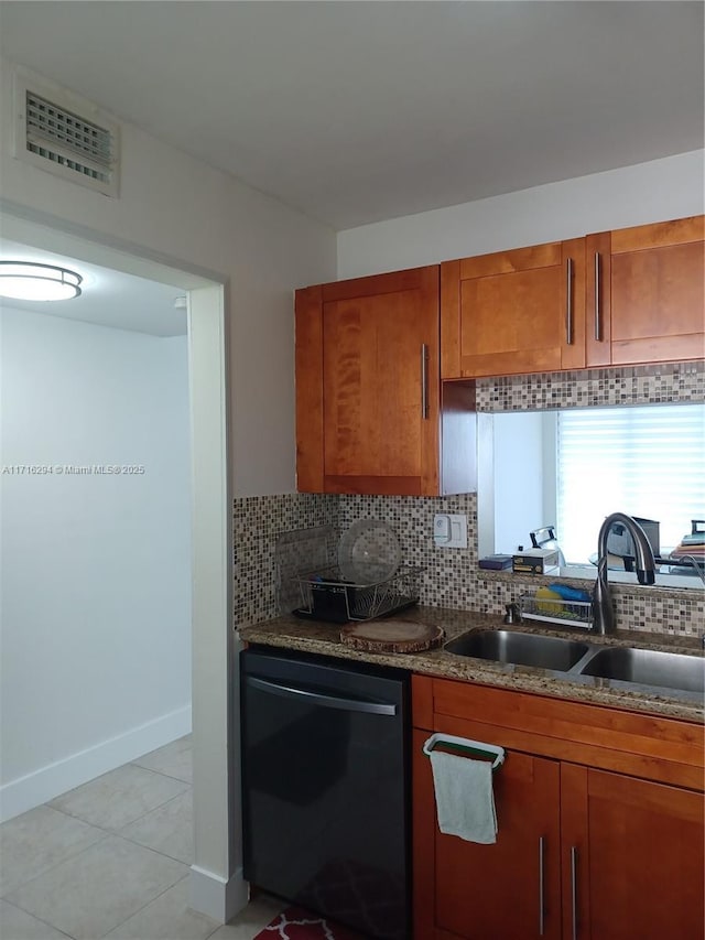 kitchen featuring backsplash, sink, black dishwasher, light tile patterned floors, and dark stone counters