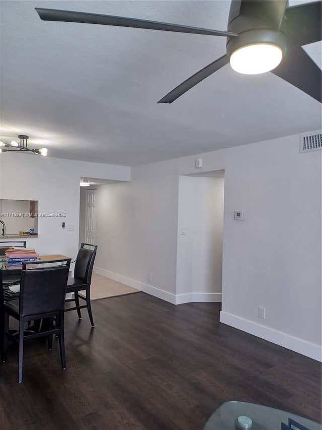 dining space with dark hardwood / wood-style floors