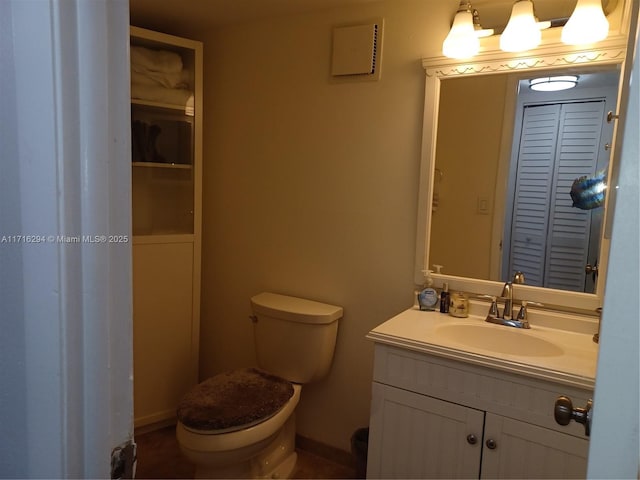 bathroom featuring toilet and vanity