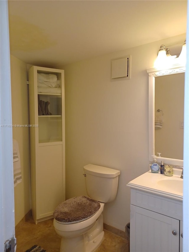 bathroom featuring toilet, tile patterned flooring, and vanity