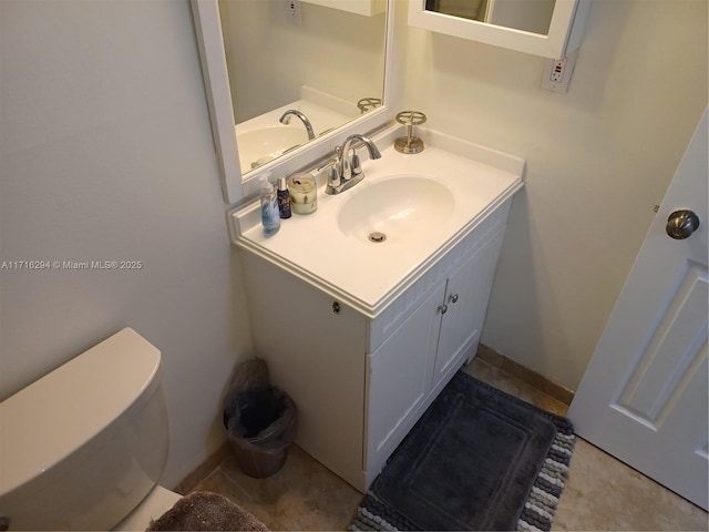 bathroom with toilet and vanity