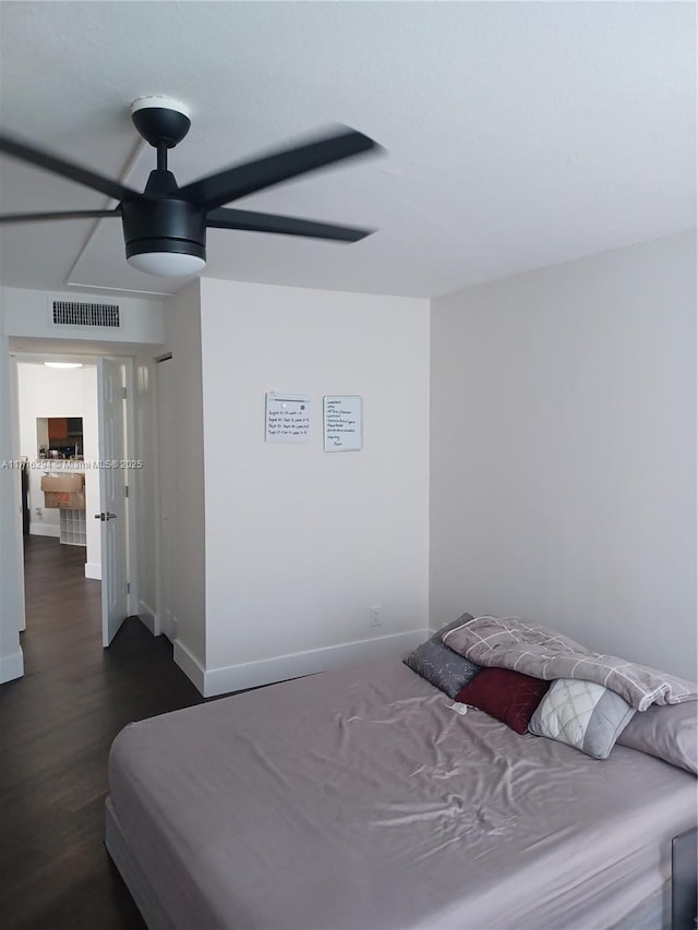 bedroom with ceiling fan and dark wood-type flooring