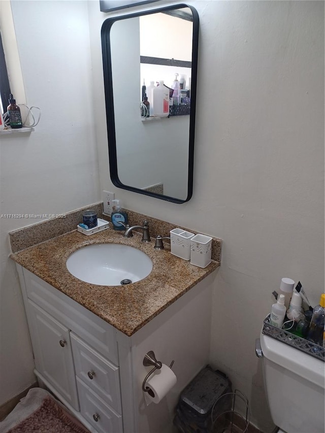 bathroom featuring toilet and vanity