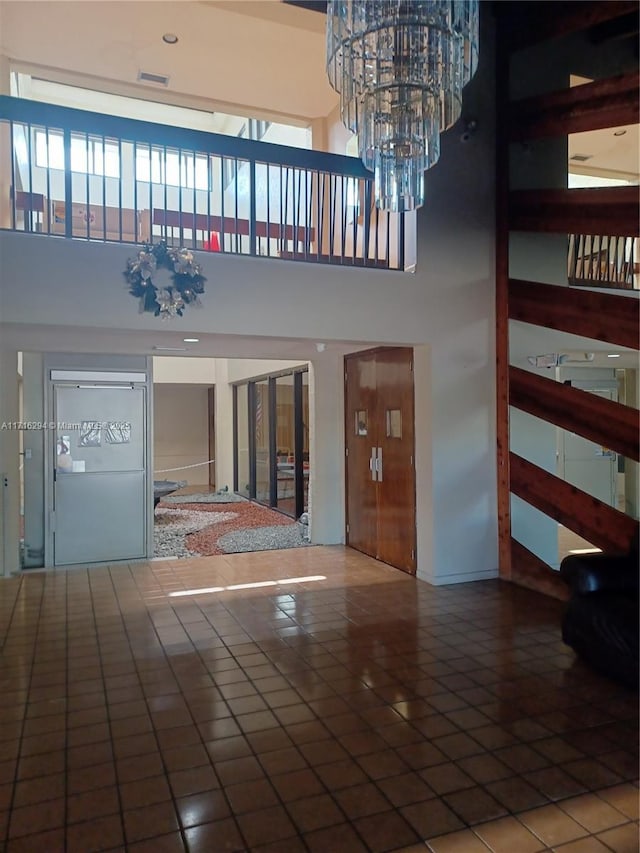 interior space with an inviting chandelier and a high ceiling