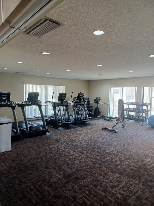 gym with a textured ceiling