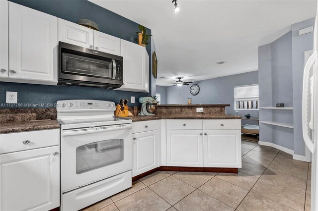 kitchen with white cabinetry, white refrigerator with ice dispenser, and light tile patterned floors