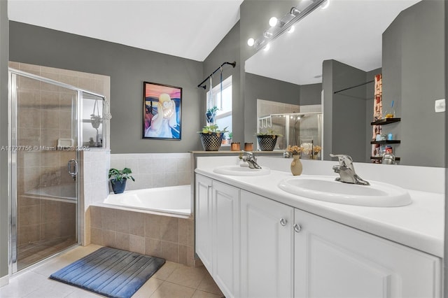 bathroom with a shower stall, a sink, and tile patterned floors