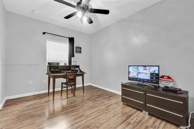 office featuring baseboards, ceiling fan, and light wood-style floors