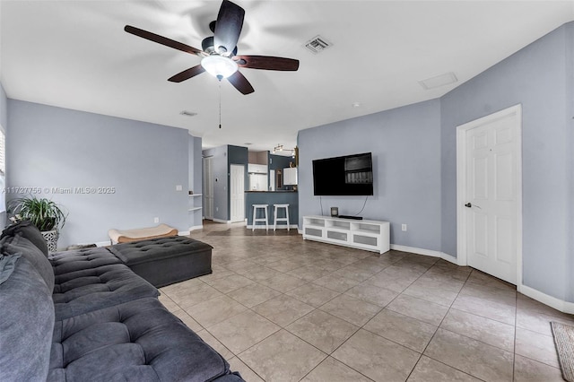 tiled living room with ceiling fan