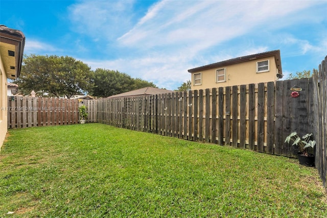view of yard with a fenced backyard