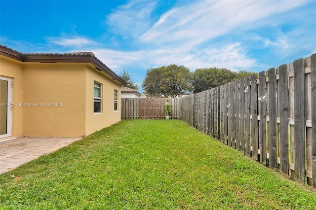 view of yard with a fenced backyard