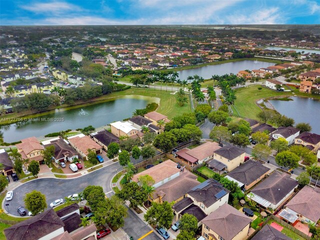 drone / aerial view featuring a water view and a residential view