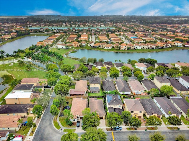 drone / aerial view with a water view and a residential view