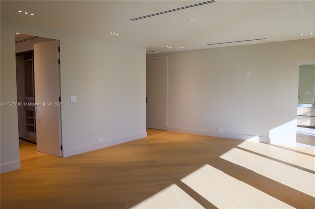 empty room with light hardwood / wood-style flooring